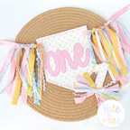 Birth/ Birthday Bean Stitch Applique Banner In The Hoop Embroidery Design: One in pink applique on a polka dot banner with pastel ribbon tassels