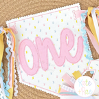 Birth/ Birthday Bean Stitch Applique Banner In The Hoop Embroidery Design: Polka dot pennant banner with one in pink applique and colorful ribbon ties