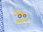 Backhoe Mini Fill Embroidery Design: Small yellow backhoe above the name Beckham stitched on a light blue shirt