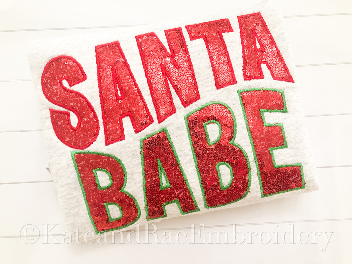 Santa Babe Satin Stitch Applique Embroidery Design: The words Santa Babe in red glitter applique letters with a green outline