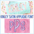 Kinley Satin Stitch Applique Embroidery Font: The name Kinley and letters PPS in floral satin applique letters on mint and pink shirts