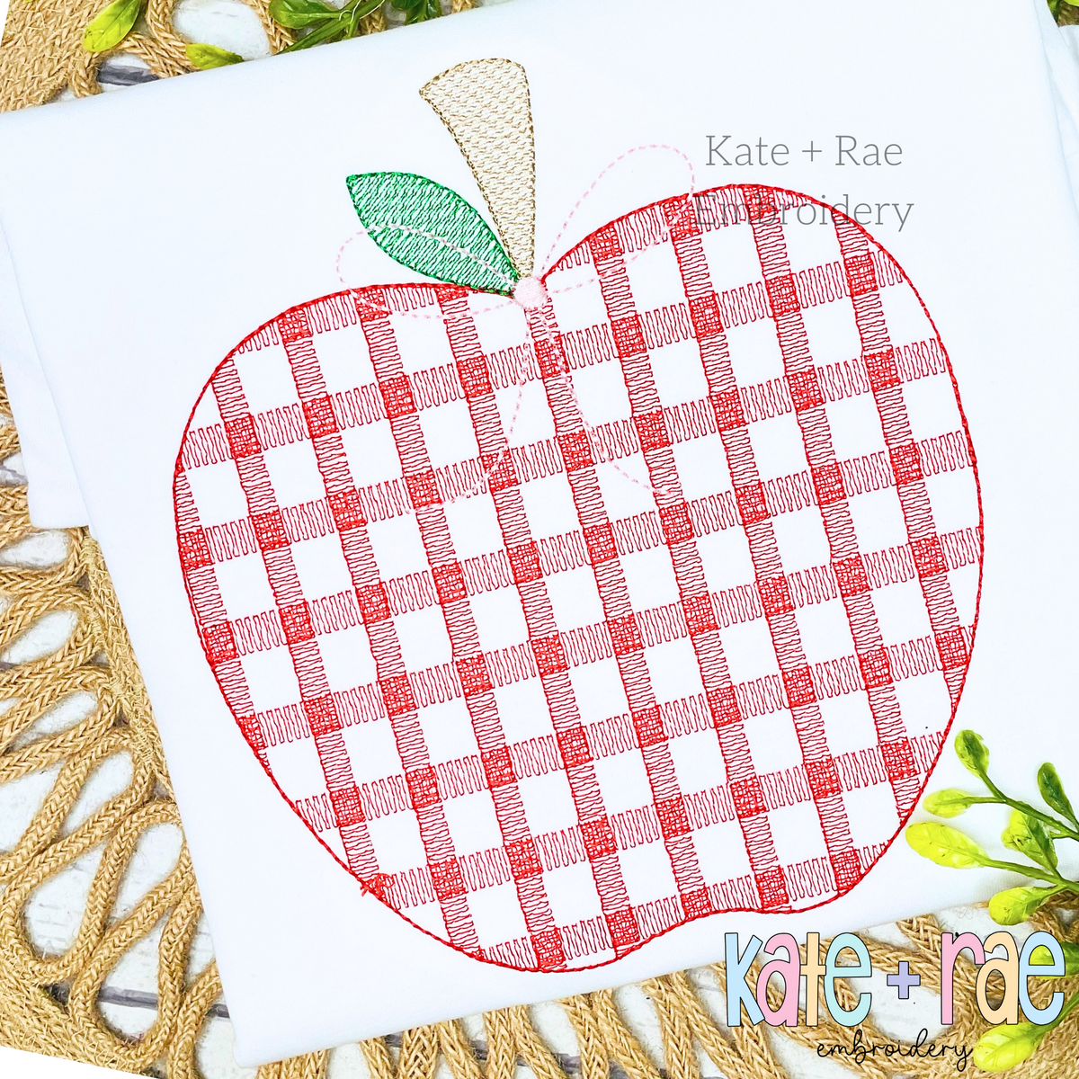Girl's Plaid Filled Apple Embroidery Design: Large red plaid sketch stitch apple with a green leaf on a white shirt