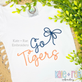 Preppy Go Tigers Embroidery Design: The words Go Tigers in navy and orange script with a navy bow on a white shirt