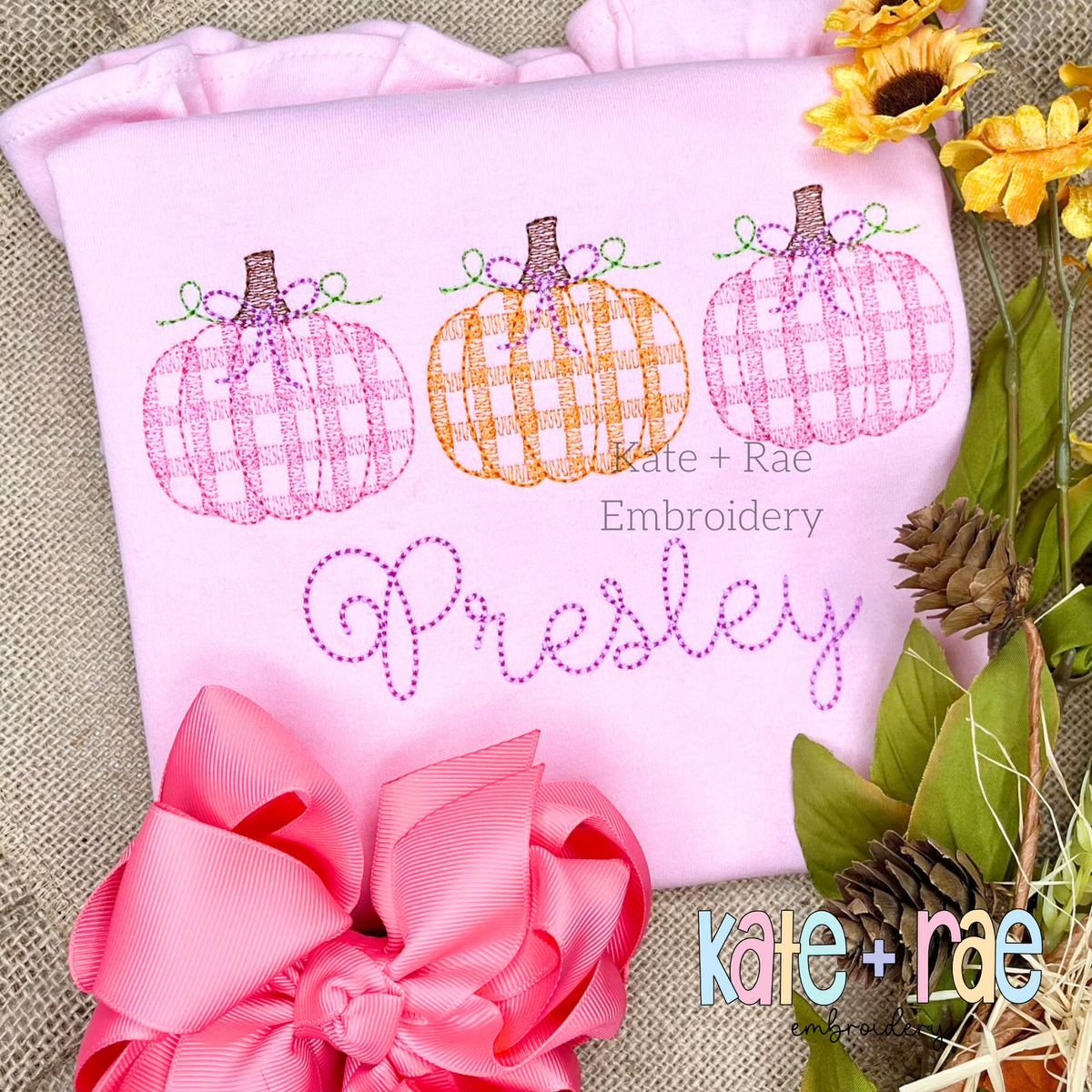Girl's Plaid Filled Pumpkins with Bows Sketch Embroidery Design: Pink and orange plaid pumpkins with bows above the name Presley in purple script on a pink shirt