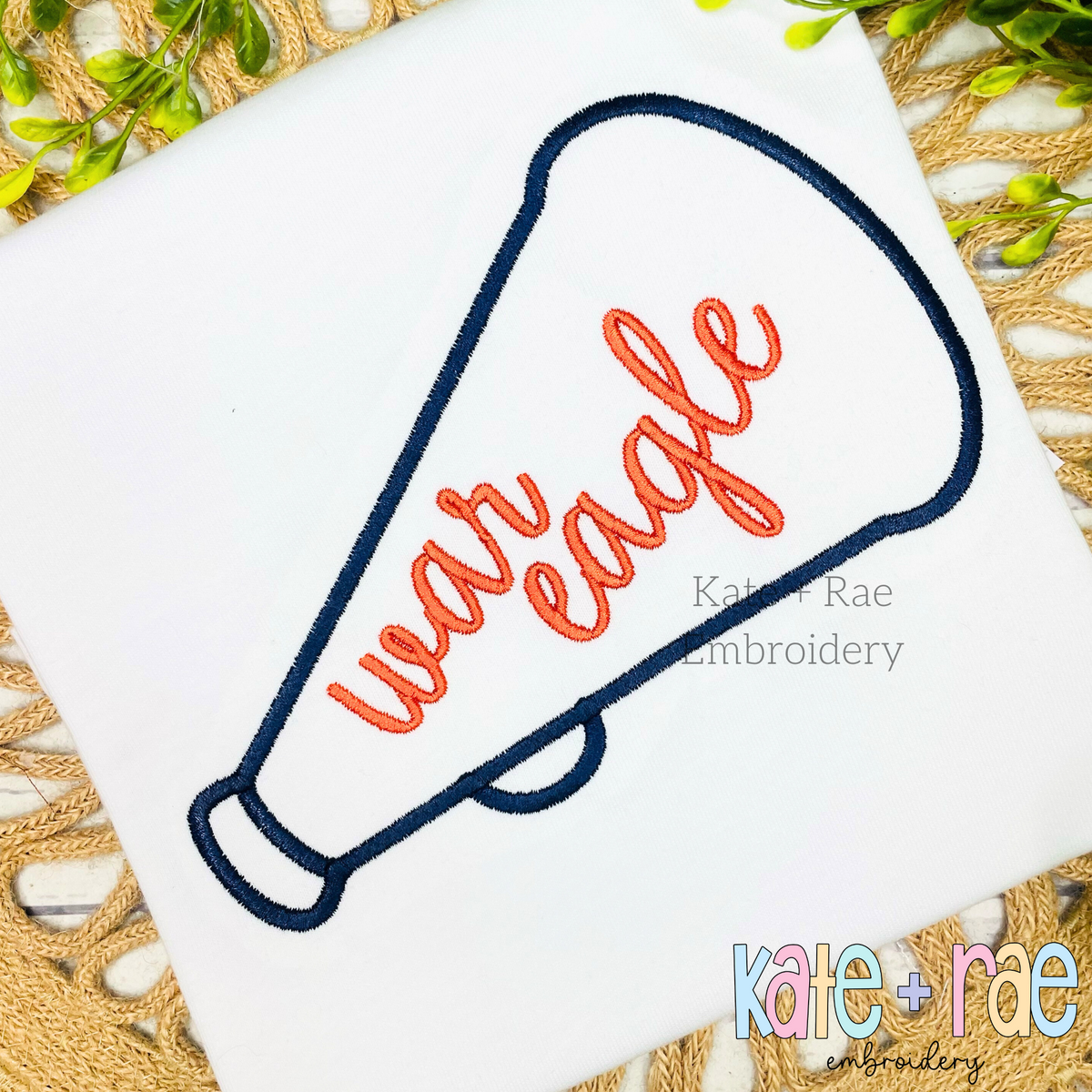 Cheer Megaphone Satin Stitch Applique Embroidery Design: Navy megaphone outline with the words war eagle in orange script on a white shirt