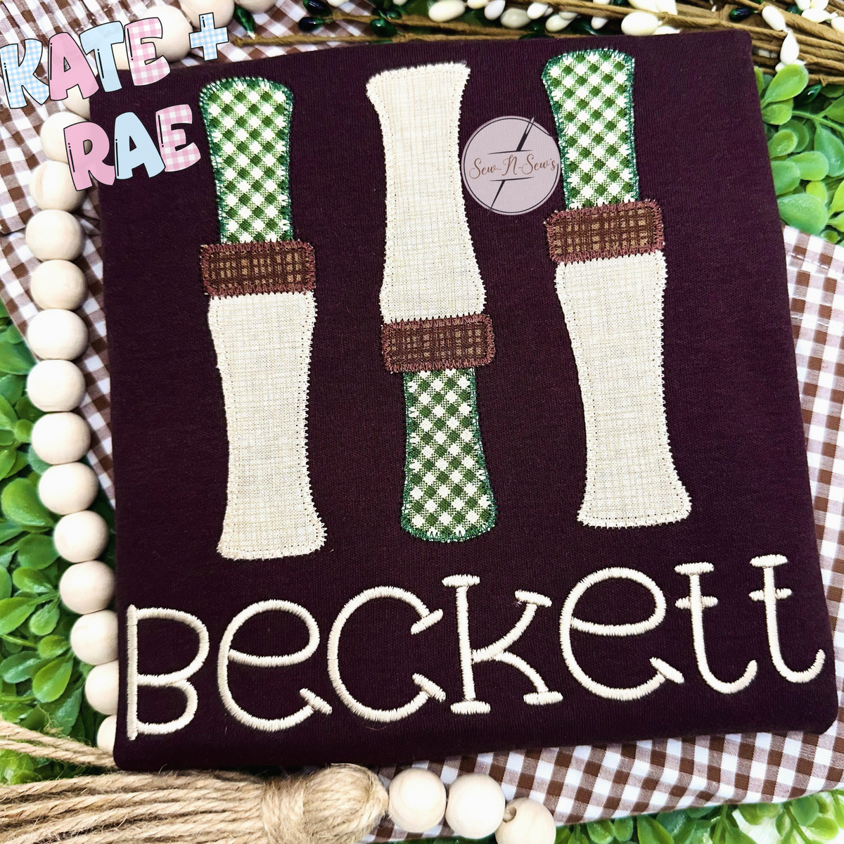 Duck Call Zigzag Applique Embroidery Design: Three green gingham and cream duck call appliques above the name Beckett on a maroon shirt