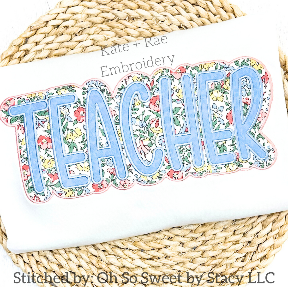 Teacher Double Satin Stitch Applique Embroidery Design: The word TEACHER in light blue applique letters with a floral print outline on a white sweatshirt