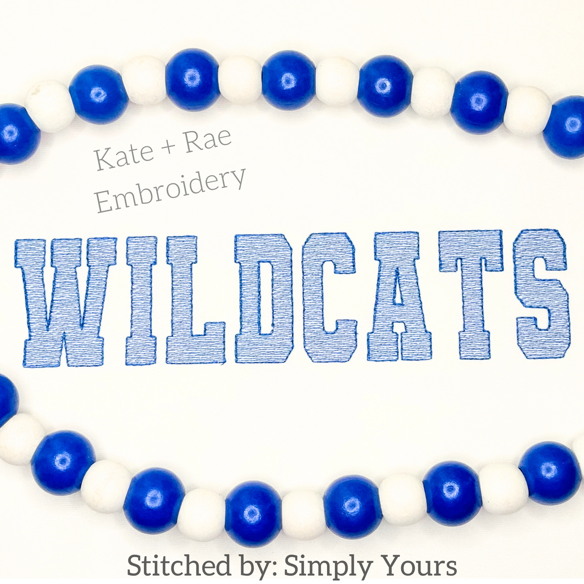 Varsity Sketch Stitch Embroidery Font: The word WILDCATS in blue collegiate sketch stitch letters on white fabric