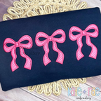 Merritt Bow Trio Satin Stitch Applique Embroidery Design: Three pink gingham Merritt bow appliques on a navy sweatshirt