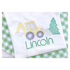 Backhoe Christmas Sketch Stitch Embroidery Design: Sketch stitch backhoe with a green Christmas tree above the name Lincoln on a white shirt over green gingham