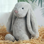 Embroidered Easter Bunnies: Gray plush bunny with long floppy ears sitting in straw