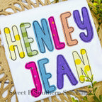 Simple Life Bean Stitch Applique Embroidery Font: The name Henley Jean in colorful patterned applique letters on a white shirt