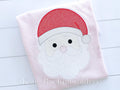 Santa Cross Stitch Sketch Embroidery Design: Cross stitch Santa face with a red hat and white beard stitched on a light pink shirt